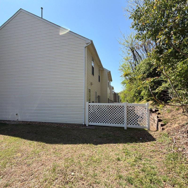 Vinyl lattice fence next to townhouse exterior wall