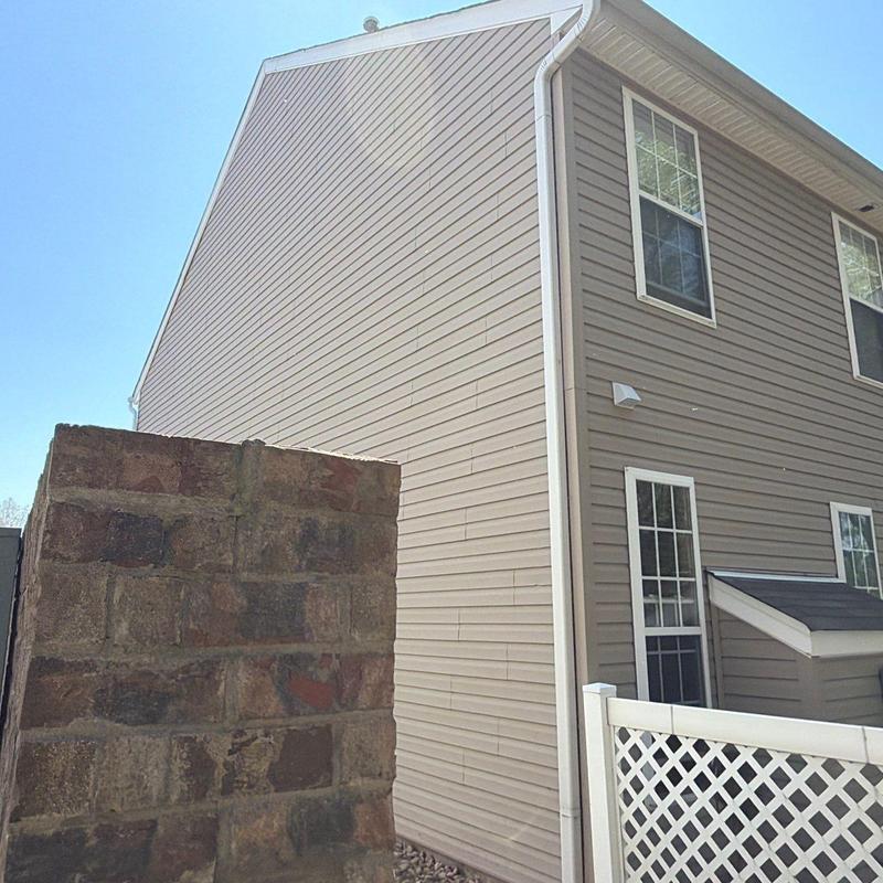 Vinyl siding and gutters on residential building exterior
