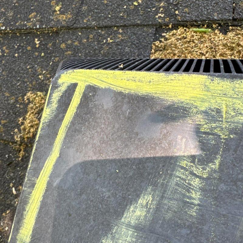 Roof shingles with chalk-marked hail damage area