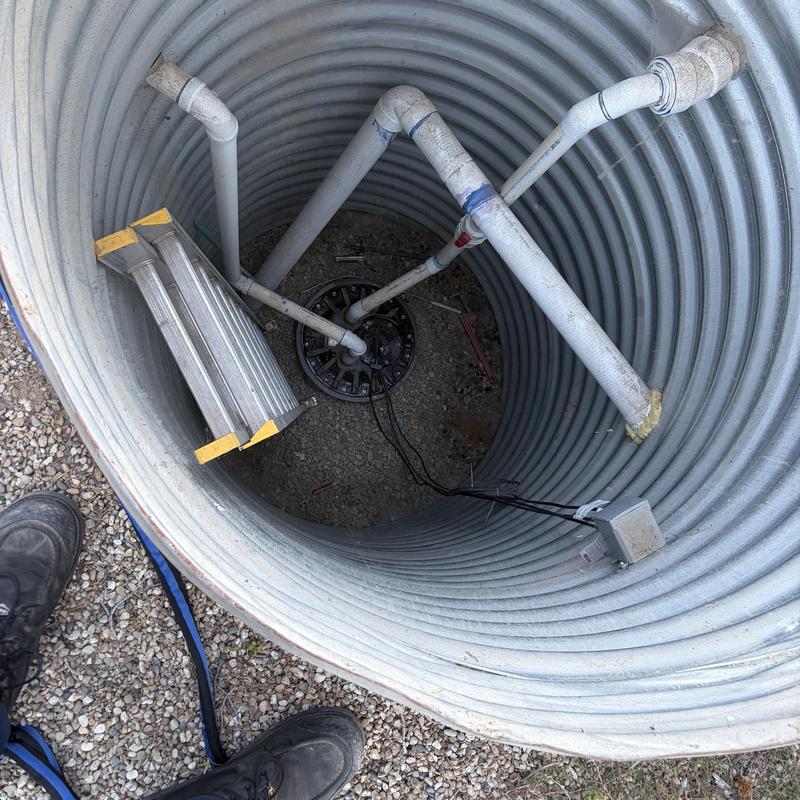 Sewage ejector grinder pump basin with ladder and pipes