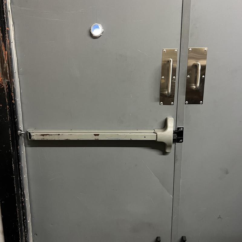 Exit device on metal door with chrome handles Exit device on metal door with chrome handles