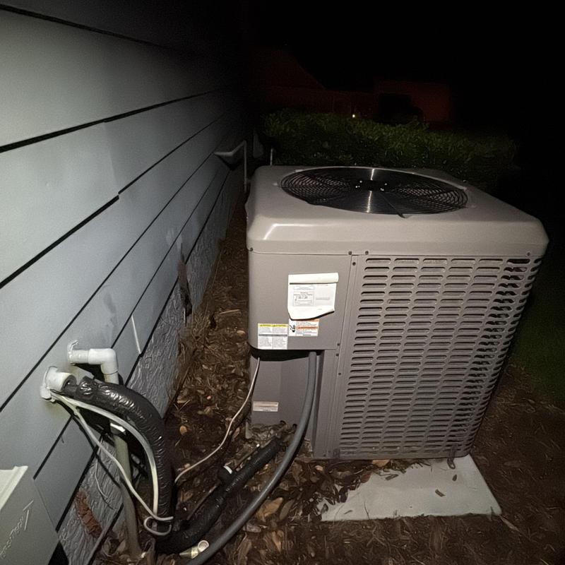 Outdoor air conditioner unit with connected pipes at night Outdoor air conditioner unit with connected pipes at night