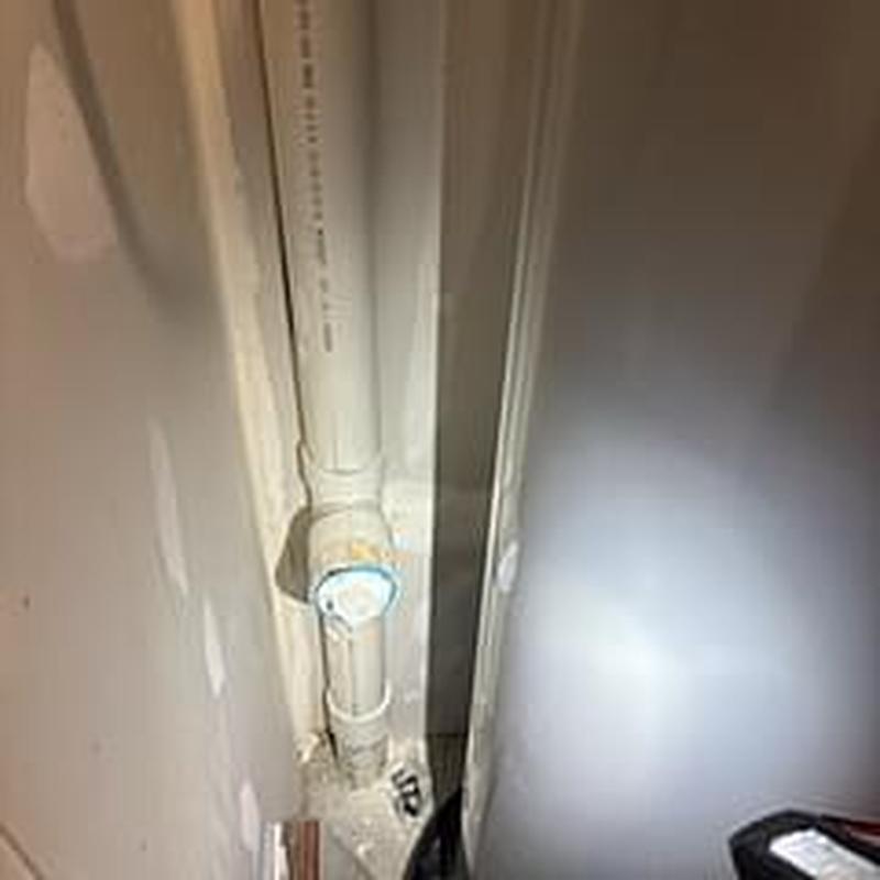 Sewer cleanout pipe with inspection cap in wall cavity