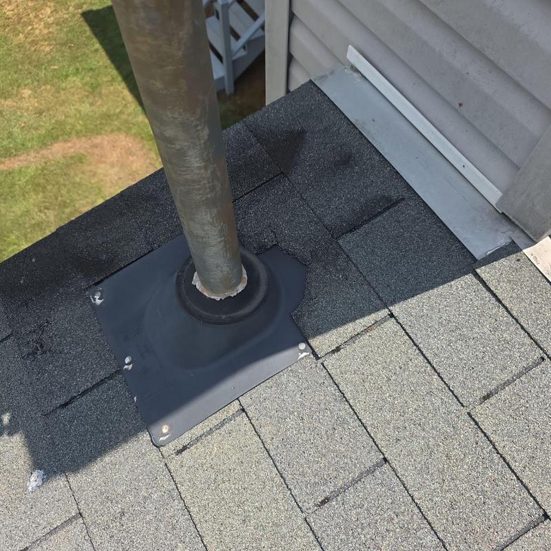 Roof pipe flashing with exposed fasteners and lifted shingles