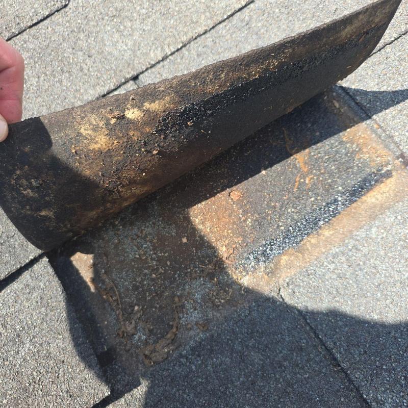 Roof shingles lifted with exposed fasteners and damage