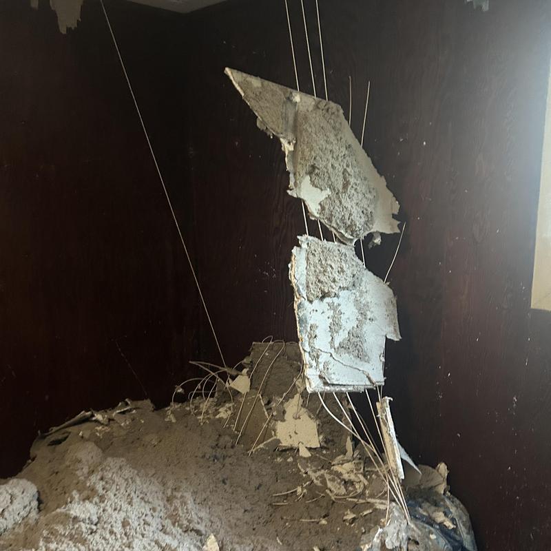Radiant heat wiring with damaged wall plaster and debris Radiant heat wiring with damaged wall plaster and debris