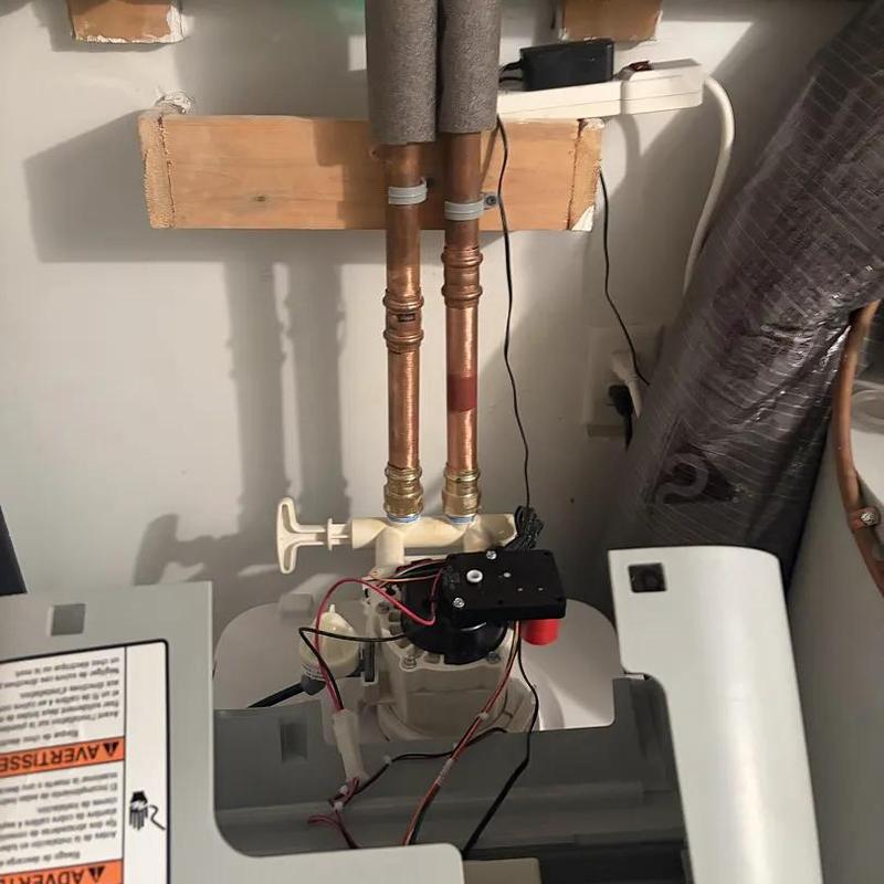 Water softener installation with copper pipes and wiring