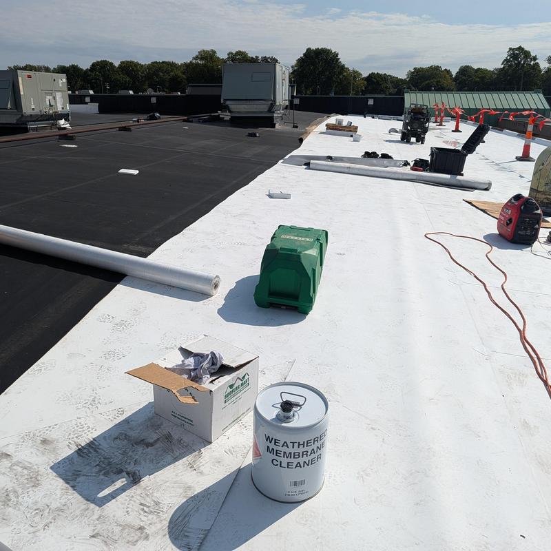 TPO single ply roof membrane with tools on flat roof