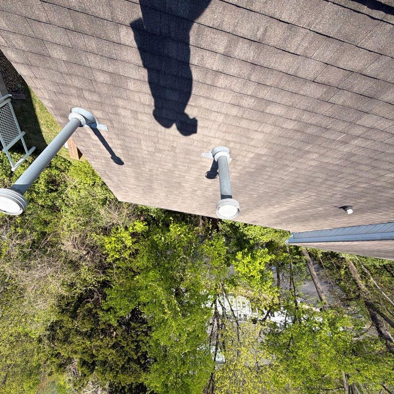 Roof shingles and vent pipes with hail damage inspection