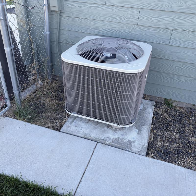 Air conditioner condenser unit beside house wall Air conditioner condenser unit beside house wall