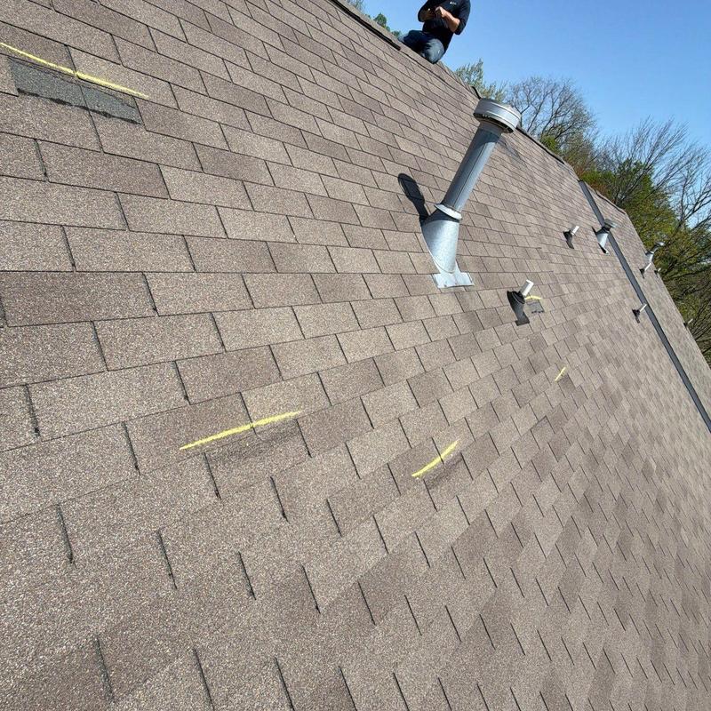 Asphalt shingle roof with hail damage markings