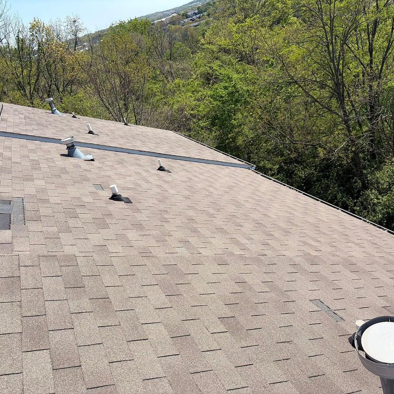 Asphalt shingle roof with ventilation pipes
