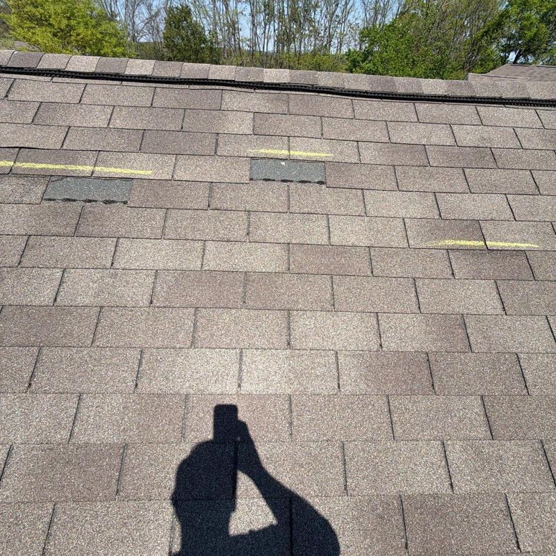 Asphalt shingle roofing with hail damage markings