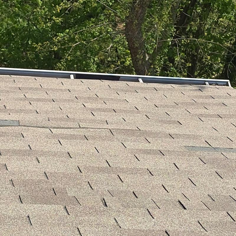 Asphalt shingles with hail damage inspection on roof