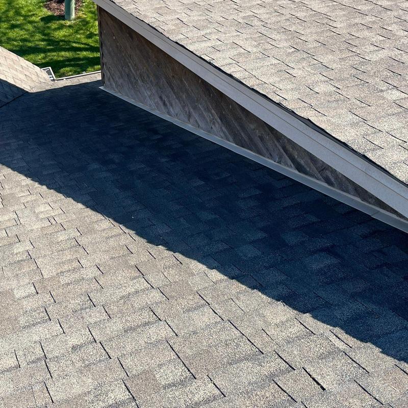 Asphalt shingle roof showing hail damage and wear