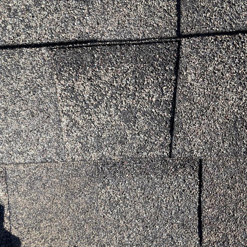 Asphalt shingles showing hail damage and wear