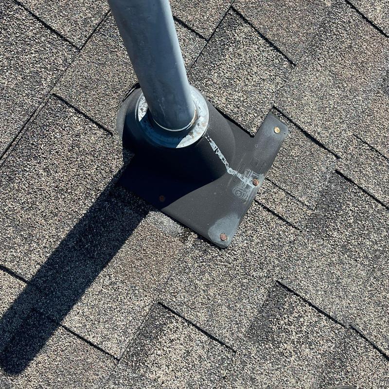Roof pipe flashing seal on asphalt shingles