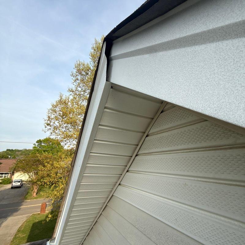 Metal gutter and soffit installation on house corner