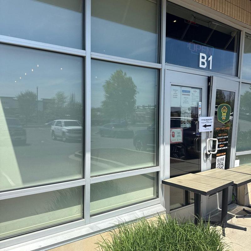 Storefront glass windows and entrance door with signage