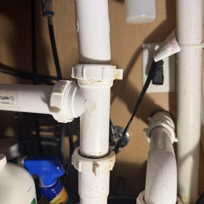 PVC drain pipe leaking under sink with loose fittings