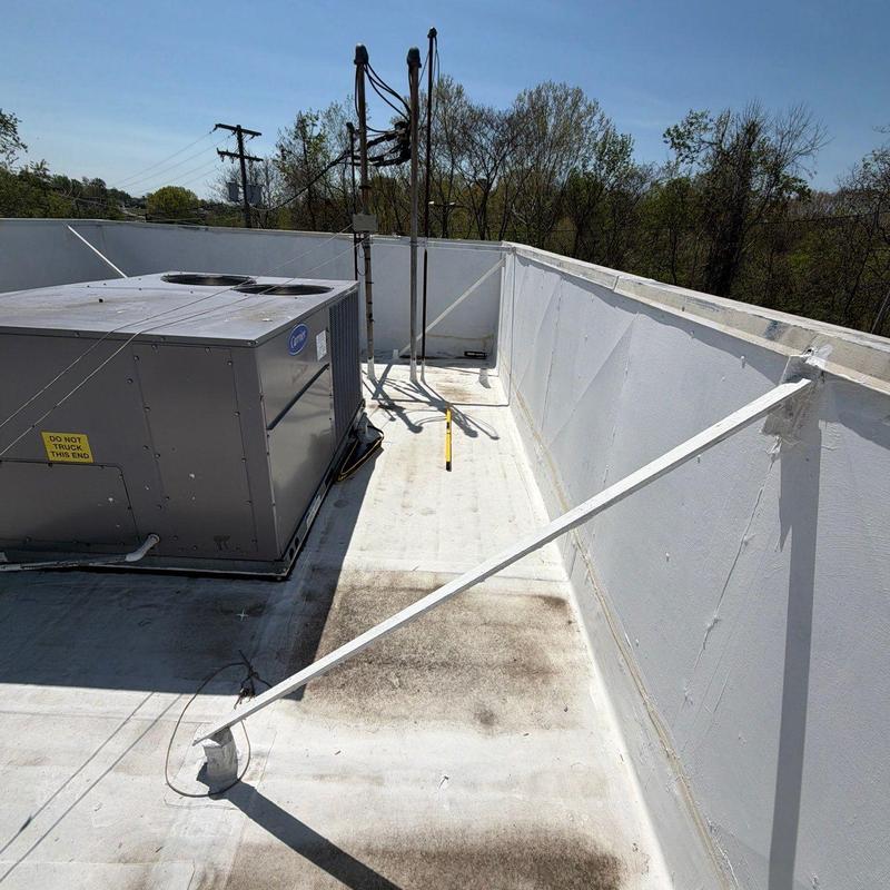 Rooftop HVAC unit and flat roof inspection in sunlight