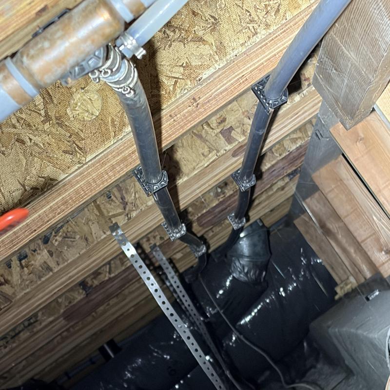 PEX water piping installation in home ceiling framing PEX water piping installation in home ceiling framing