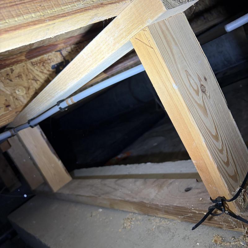 PEX water piping installed in crawl space framing PEX water piping installed in crawl space framing