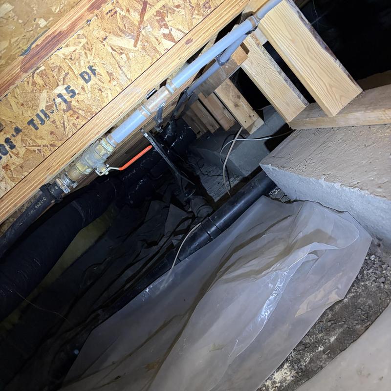 PEX water piping installation in crawl space under home PEX water piping installation in crawl space under home