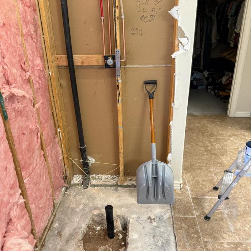 Shower drain pipe installation with wall framing exposed