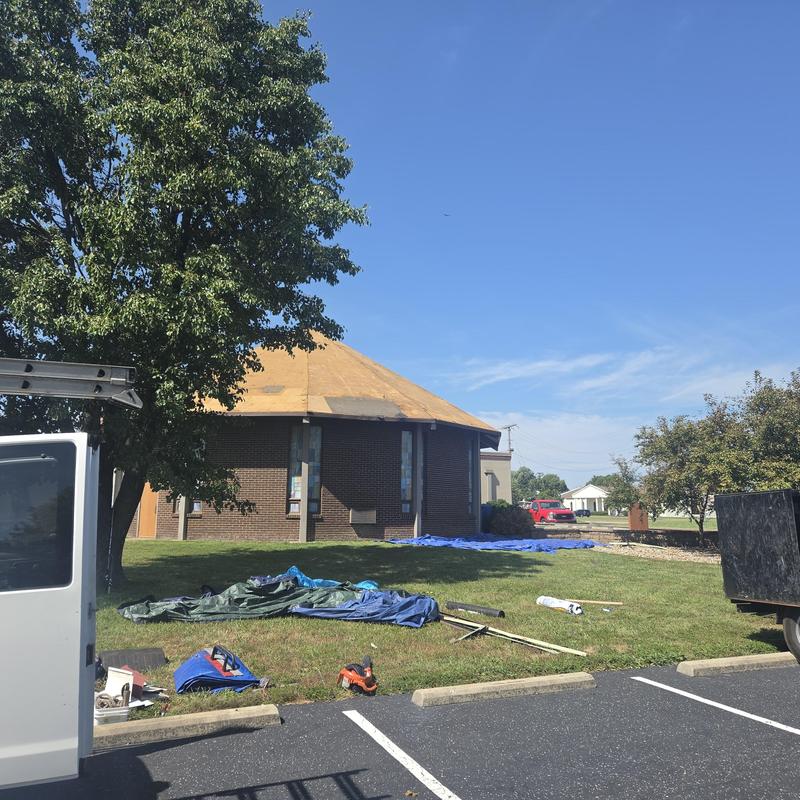 Metal roof with removed panels on church job site