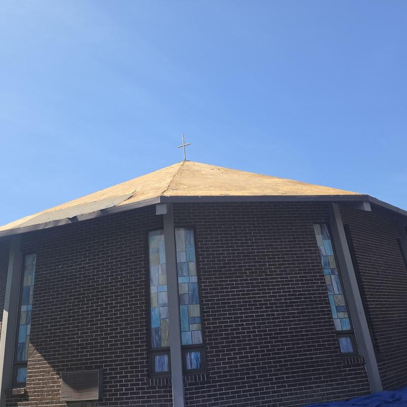 Metal roof decking on church under clear sky