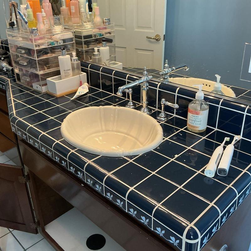 Bathroom faucet and blue tiled vanity countertop installation Bathroom faucet and blue tiled vanity countertop installation