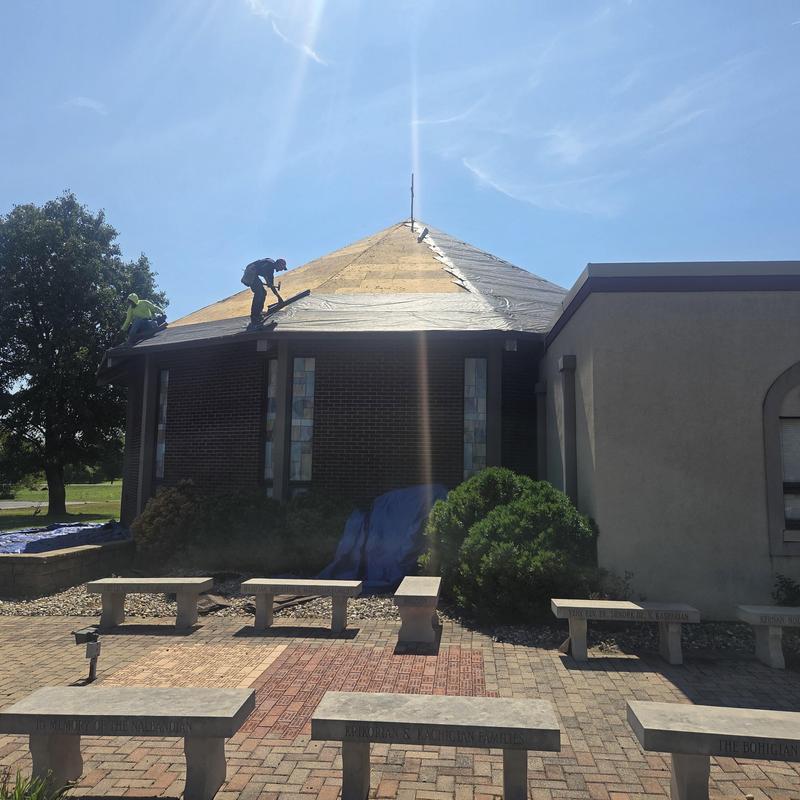 Metal roof deck underlayment installation on church roof