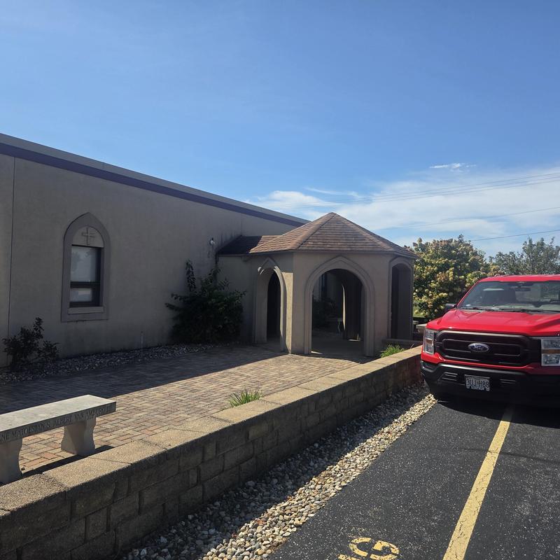 Metal roof installation with copper color near church entrance
