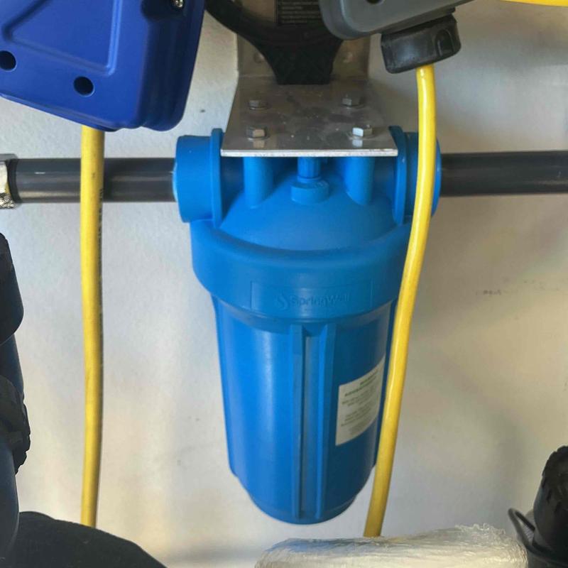 Water filter housing with yellow electrical cords Water filter housing with yellow electrical cords