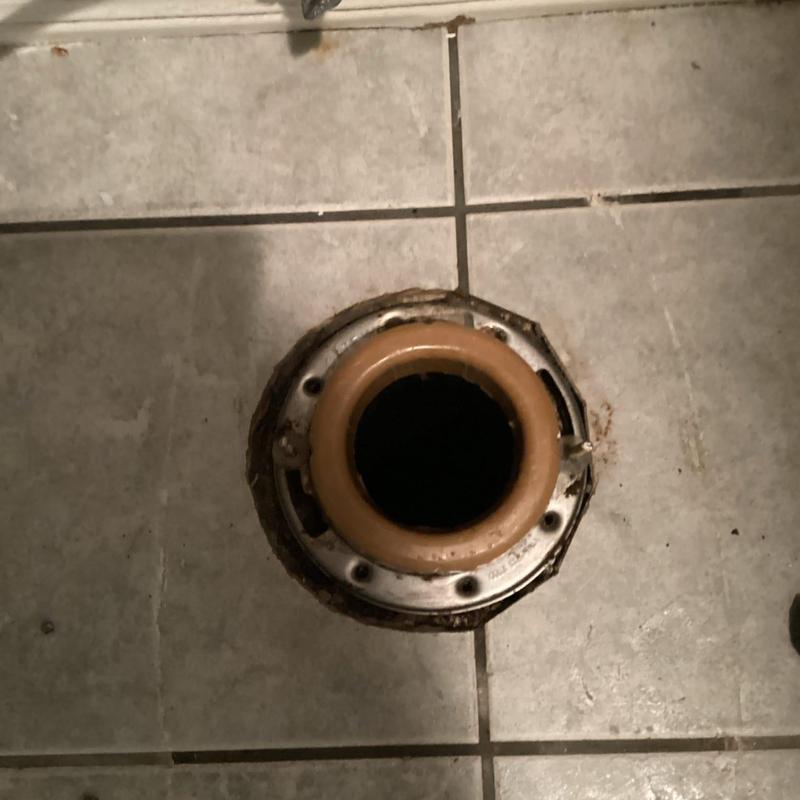 Toilet flange with wax ring on tiled floor Toilet flange with wax ring on tiled floor