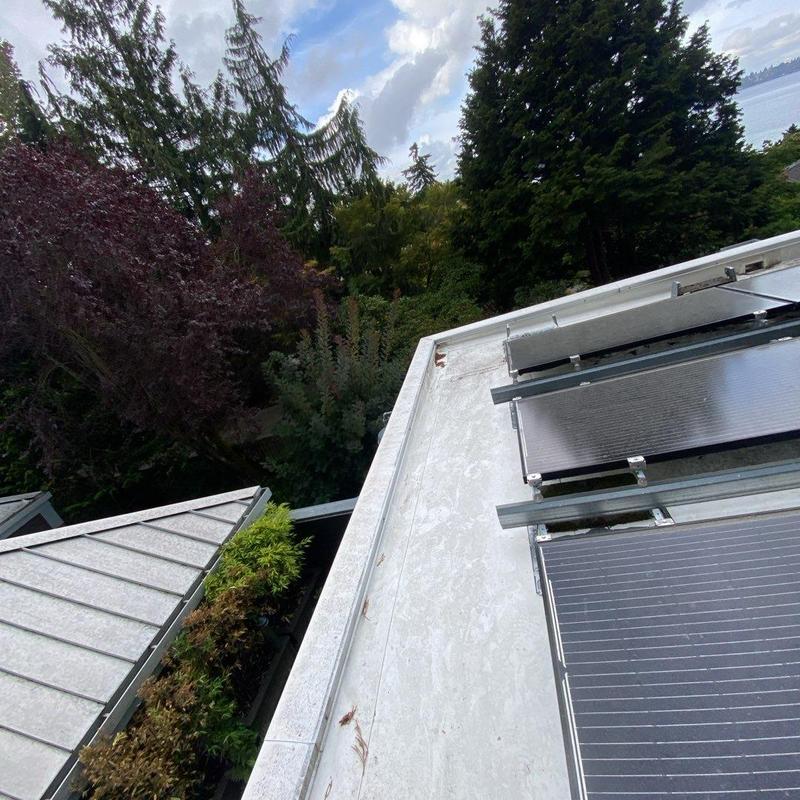 Solar panel system on roof with surrounding trees