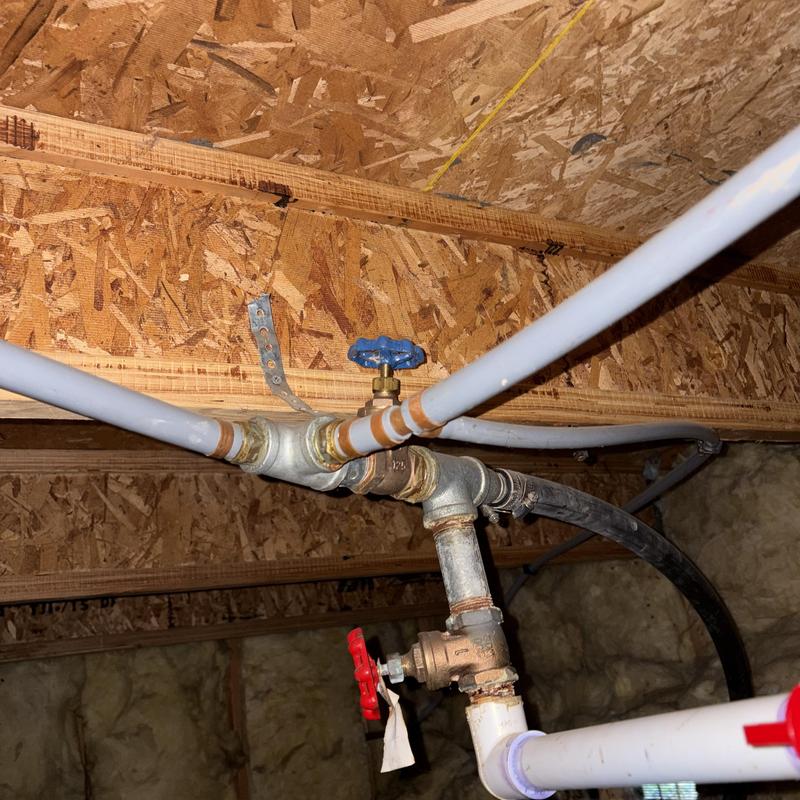 Water shut-off valves and piping under floor joists Water shut-off valves and piping under floor joists