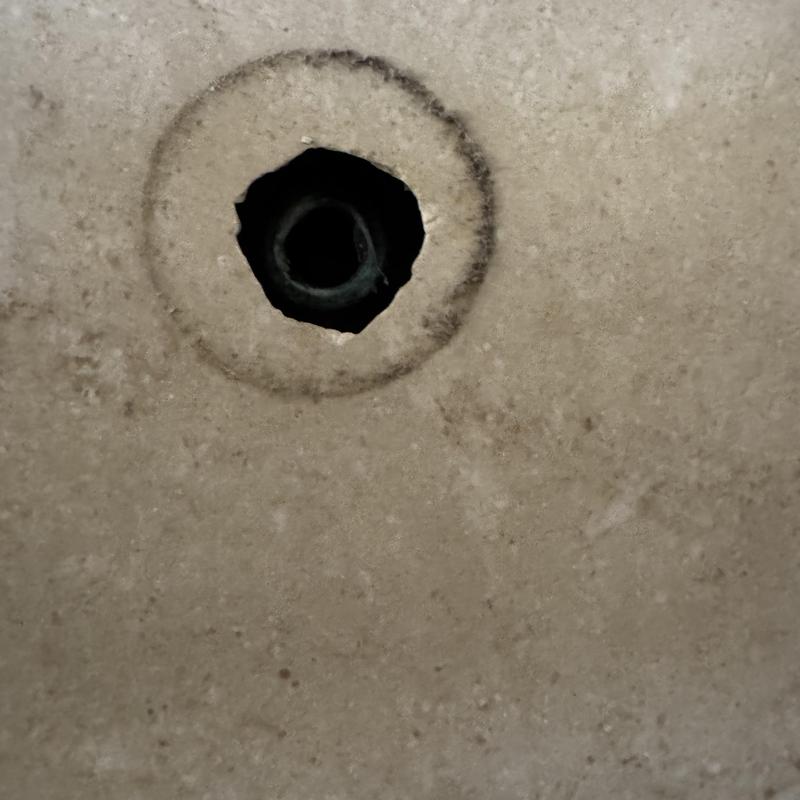 Shower arm mounting hole in tile wall during repair Shower arm mounting hole in tile wall during repair