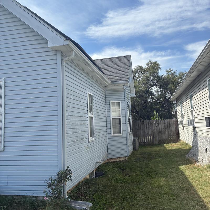 Vinyl siding exterior of residential house in sunlight