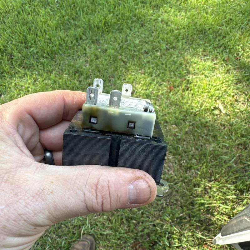 HVAC transformer held in hand after replacement HVAC transformer held in hand after replacement