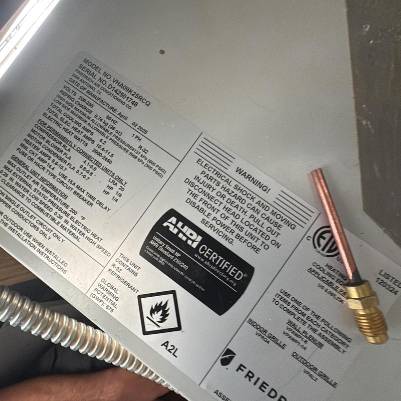 Air conditioner model and safety warning label close-up Air conditioner model and safety warning label close-up