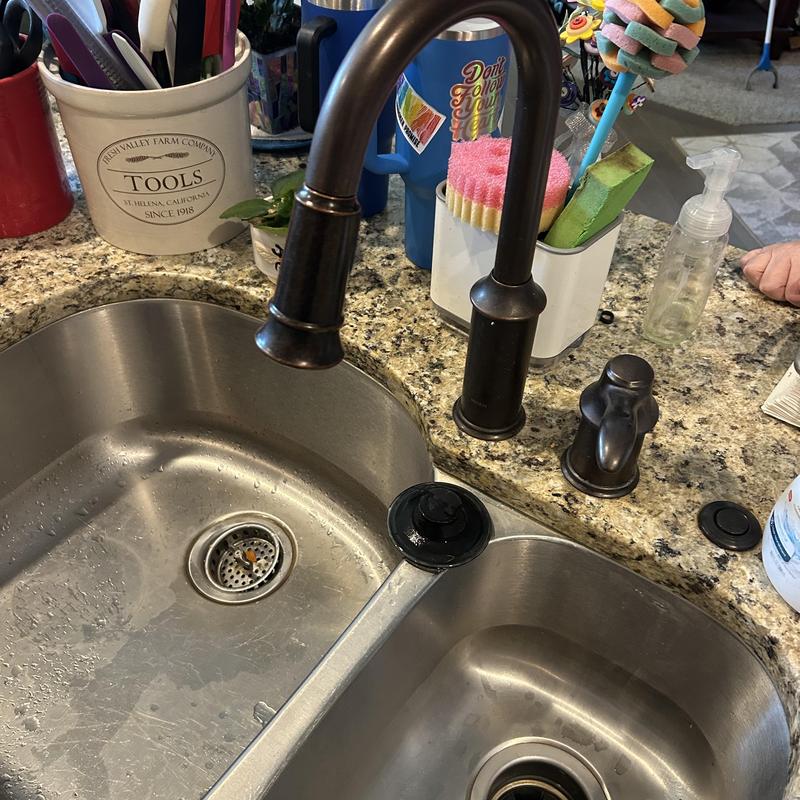 Kitchen sink faucet and soap dispenser on granite counter Kitchen sink faucet and soap dispenser on granite counter