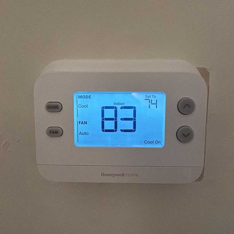 Honeywell Home thermostat with digital display installed on wall Honeywell Home thermostat with digital display installed on wall