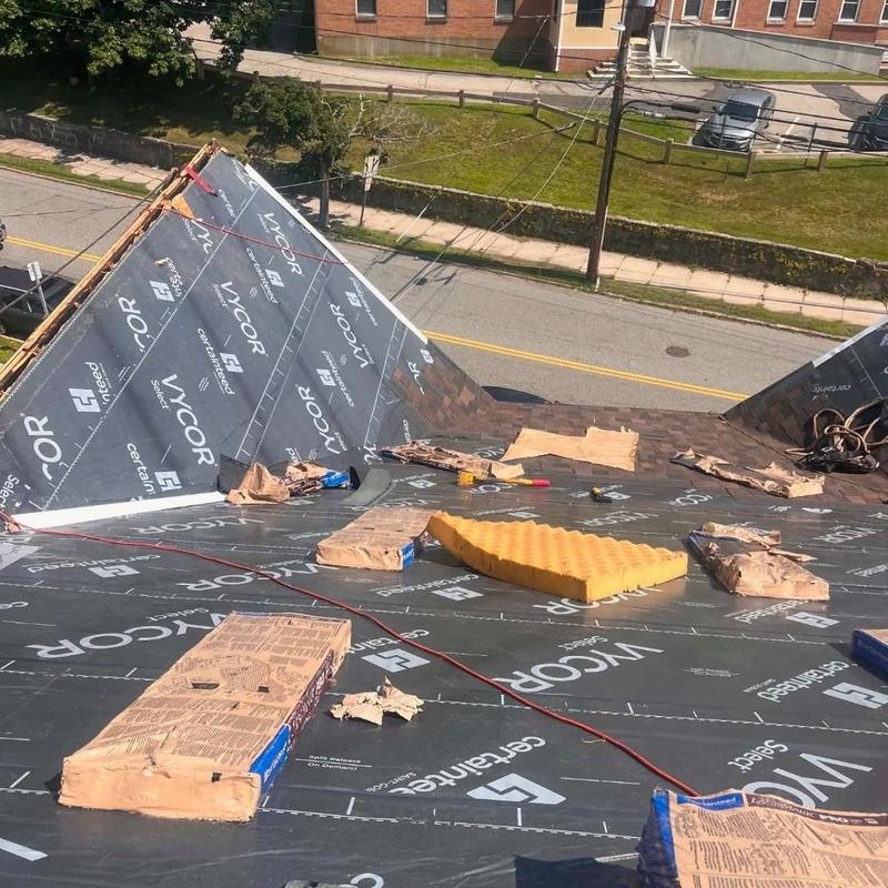 Roof underlayment installation on residential roof in New London