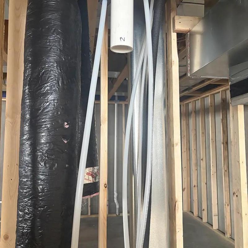 PEX plumbing pipes with ductwork in home framing