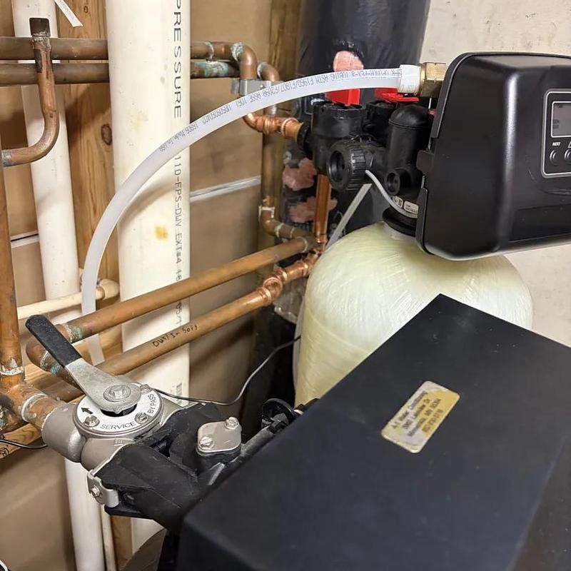 Water softener system with control valve and pipes