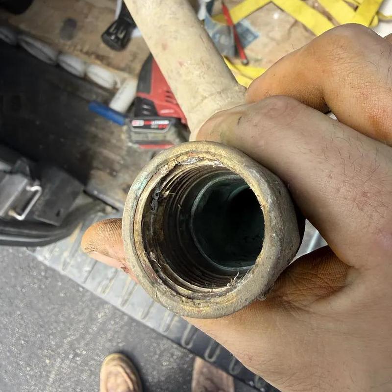 Threaded irrigation pipe fitting held in hand