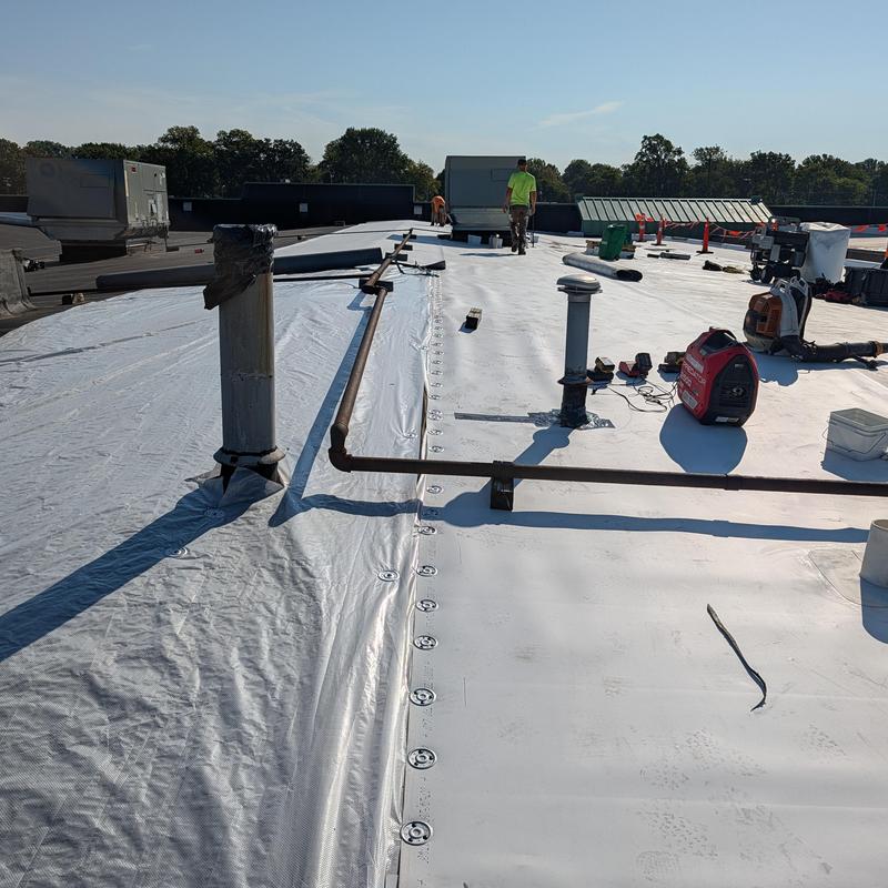 TPO commercial roofing membrane installation on flat roof