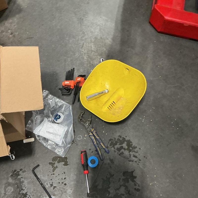 Emergency eyewash station and plumbing tools on floor Emergency eyewash station and plumbing tools on floor